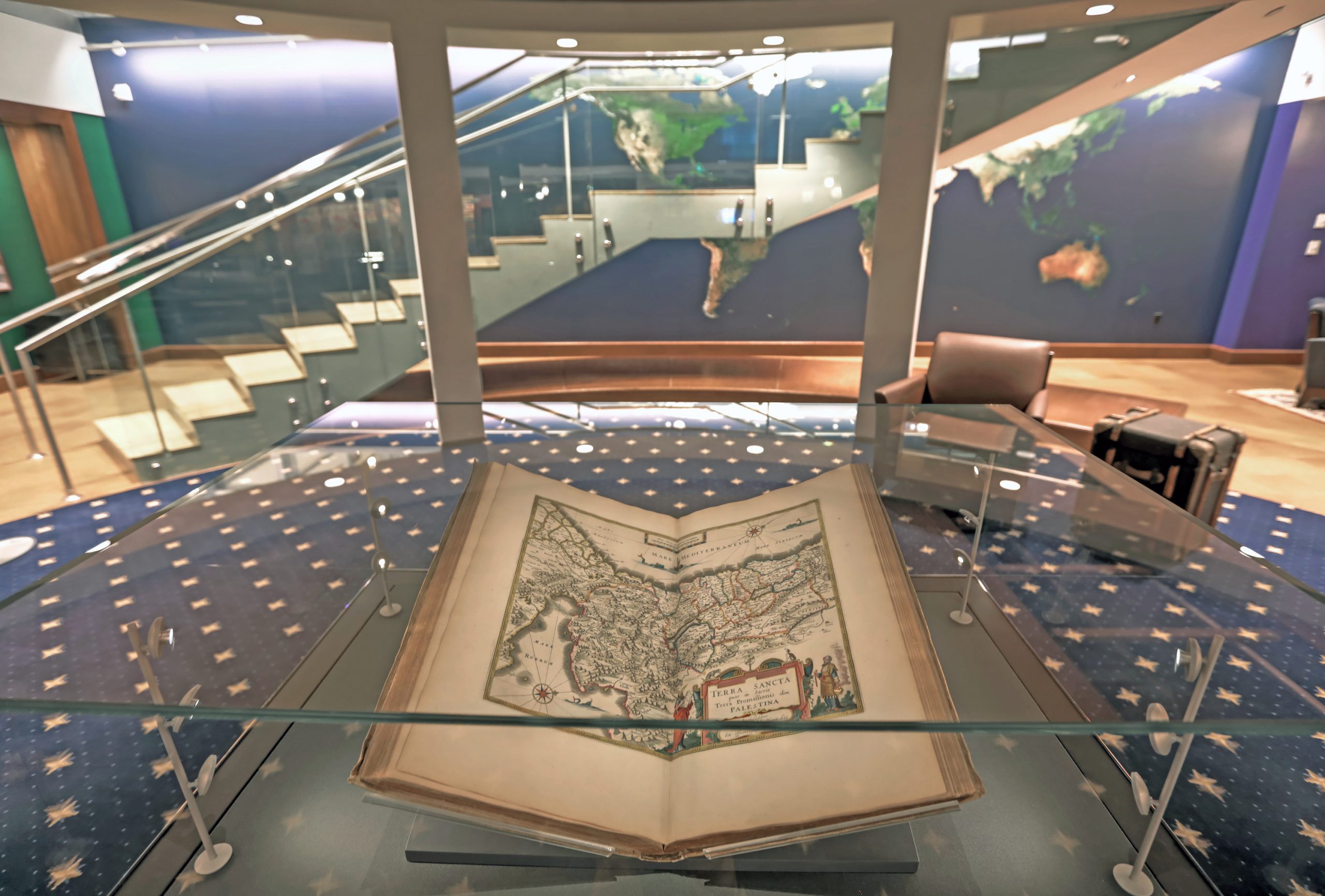 The Blaeu Atlas open to a map at the base of Olin Library's Andrew and Jayne Kagan Grand Staircase in the Newman Exploration Center (Level A).