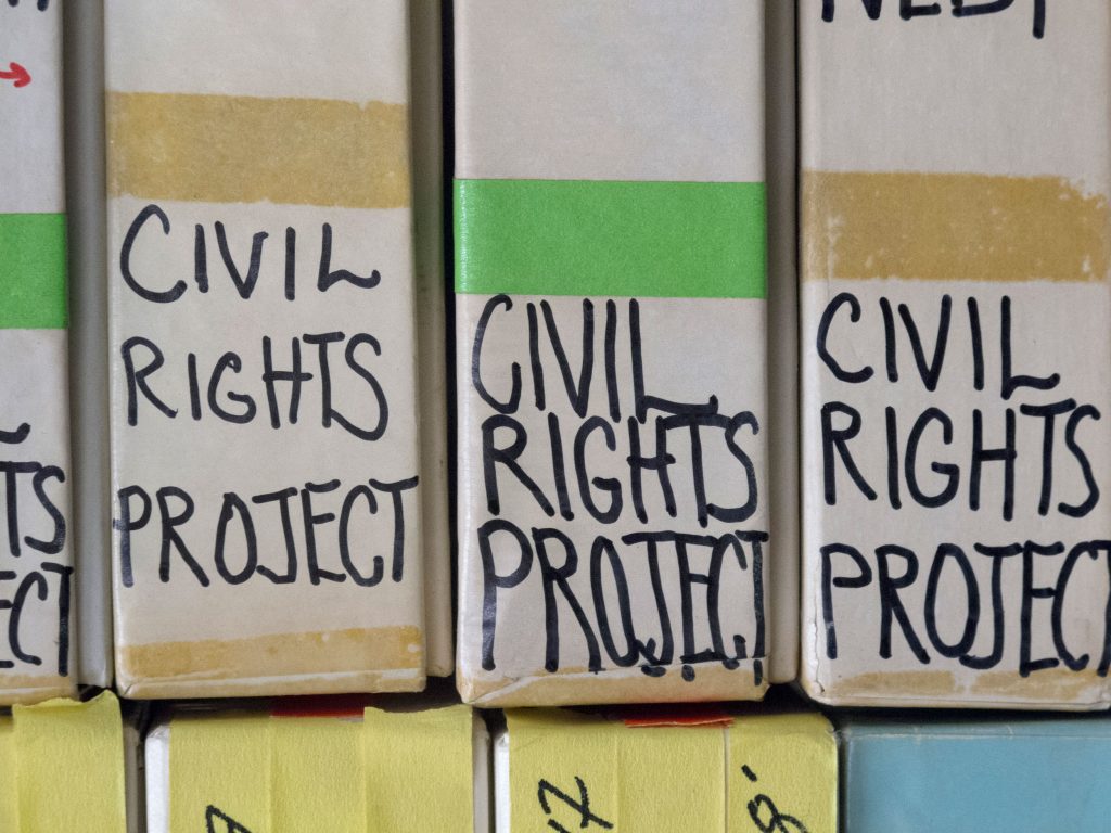 Close-up on the "CIVIL RIGHTS PROJECT" sticker labels on the film boxes.