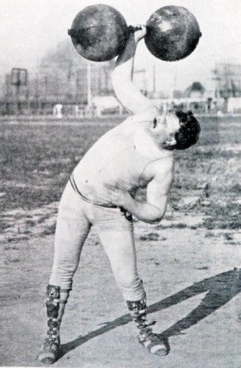 USA's Frederick Winters lifting a dumbbell during the 1904 Olympic Games. Winters on the silver medal for this event. 