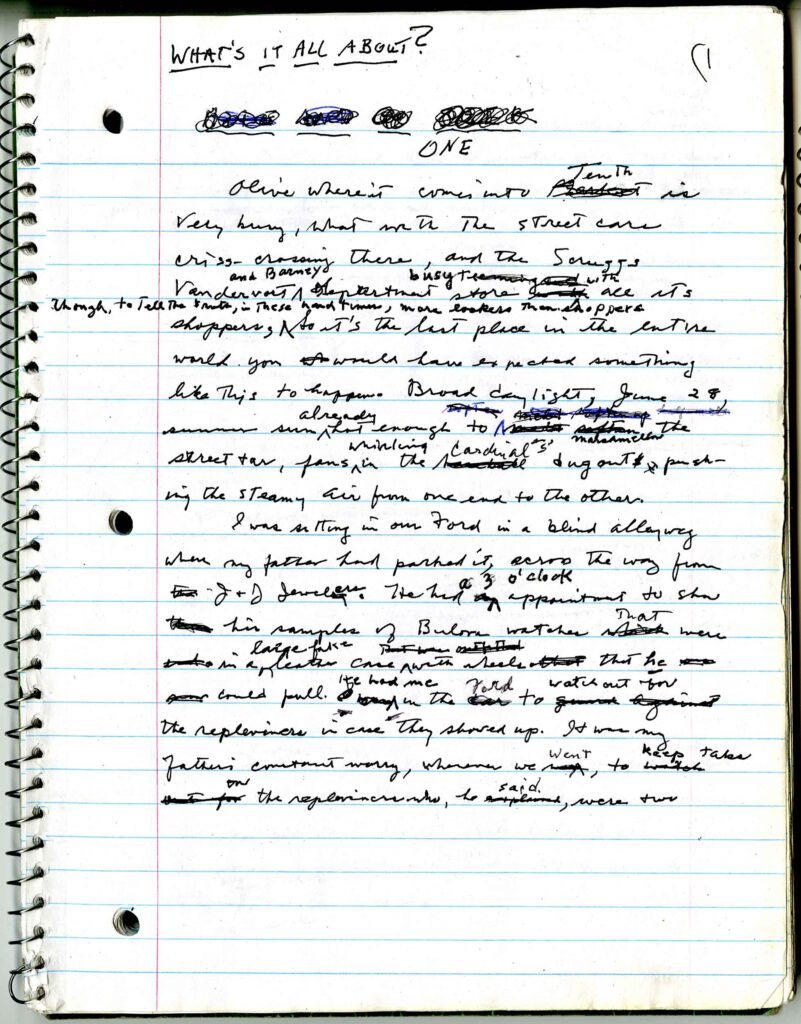 The manuscript is on a lined, spiral notebook and is written in cursive with many items crossed-out or annotated in margins. The top of the page reads "What's It All About?" and is marked with a 1 to indicate pagination. 