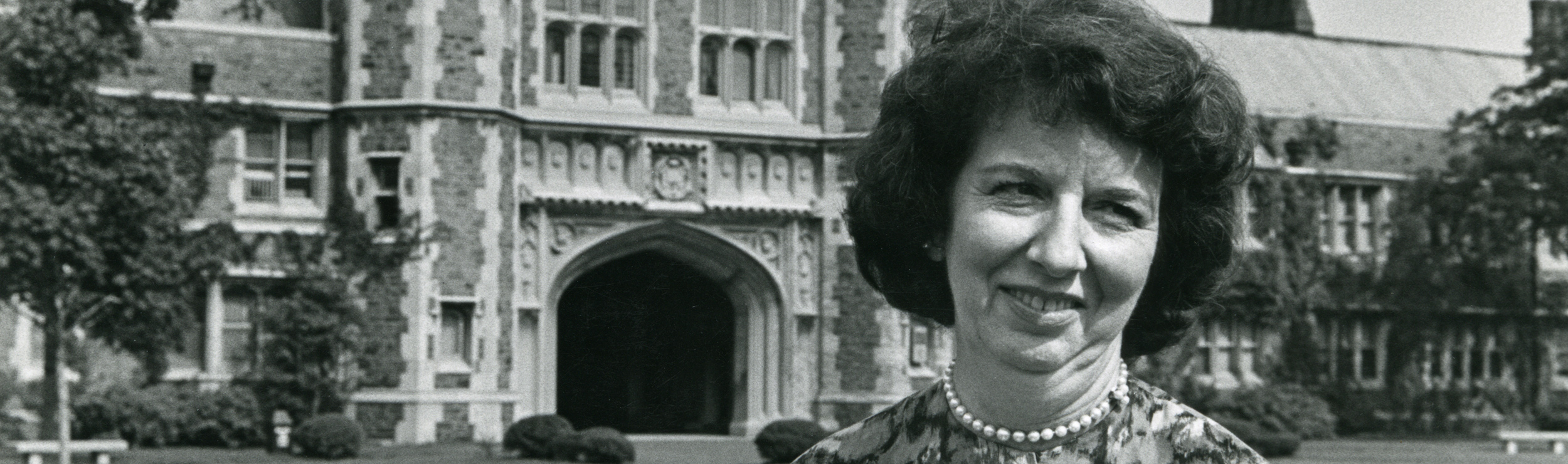 Image shows Mary Wickes standing in front of a building on the Washington University in St. Louis campus.