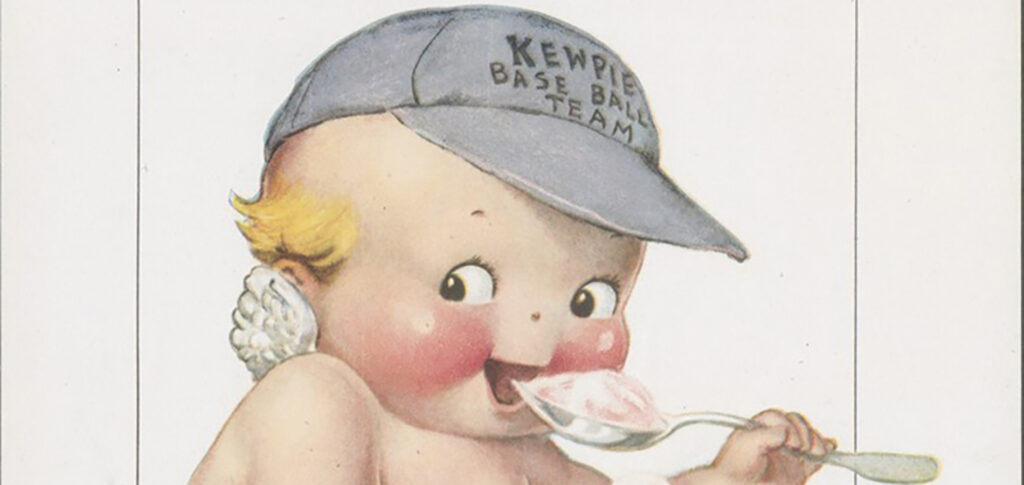 A baby, or "kewpie" as created by the illustrator Rose O'Neill, is eating ice cream. He has small angel wings and wears a baseball cap labeled "Kewpie Base Ball Team."