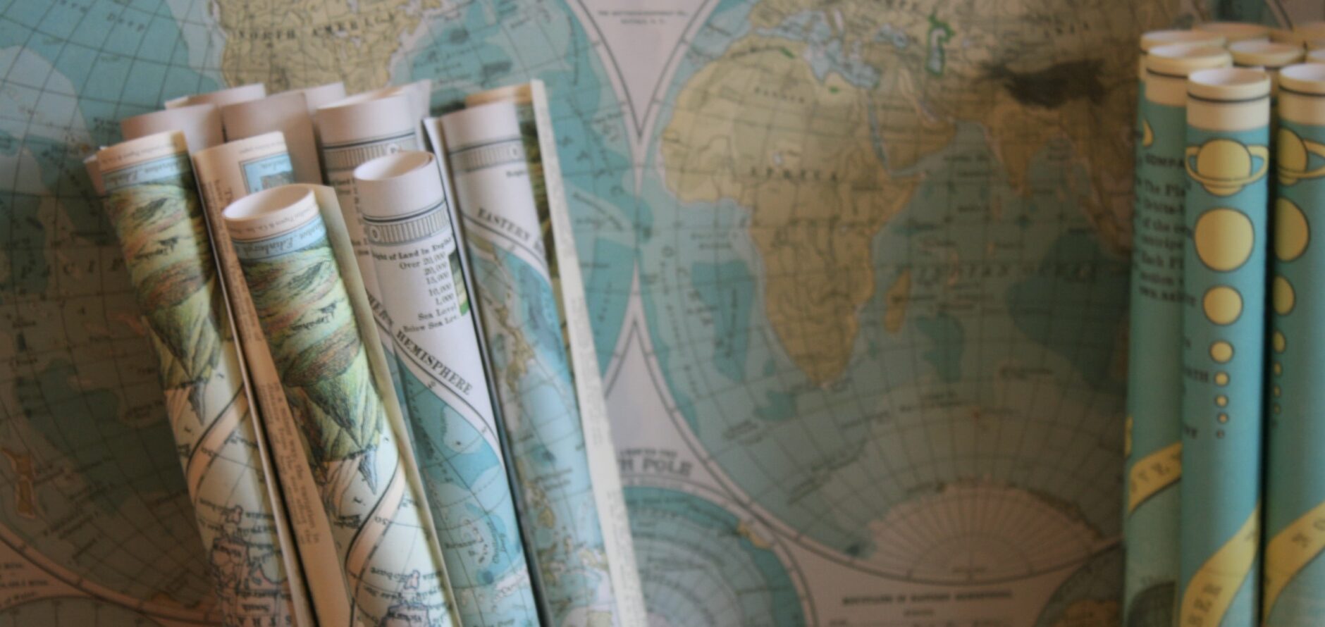 Stock image of rolled and flat maps.