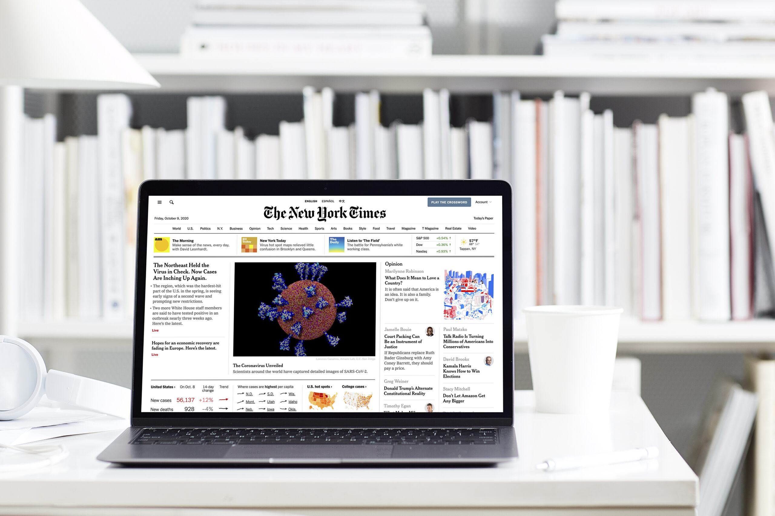 The image shows a computer open with the New York Times website pulled up on-screen.