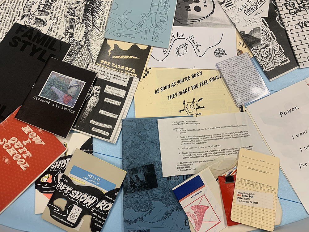 A collage of even more zines showcased in the Ideas, Art, and Community Collect O'Rama exhibition case.