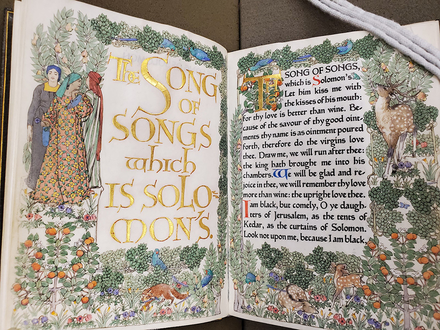 The first page of Song of Solomon with an intricately colored forest scene.