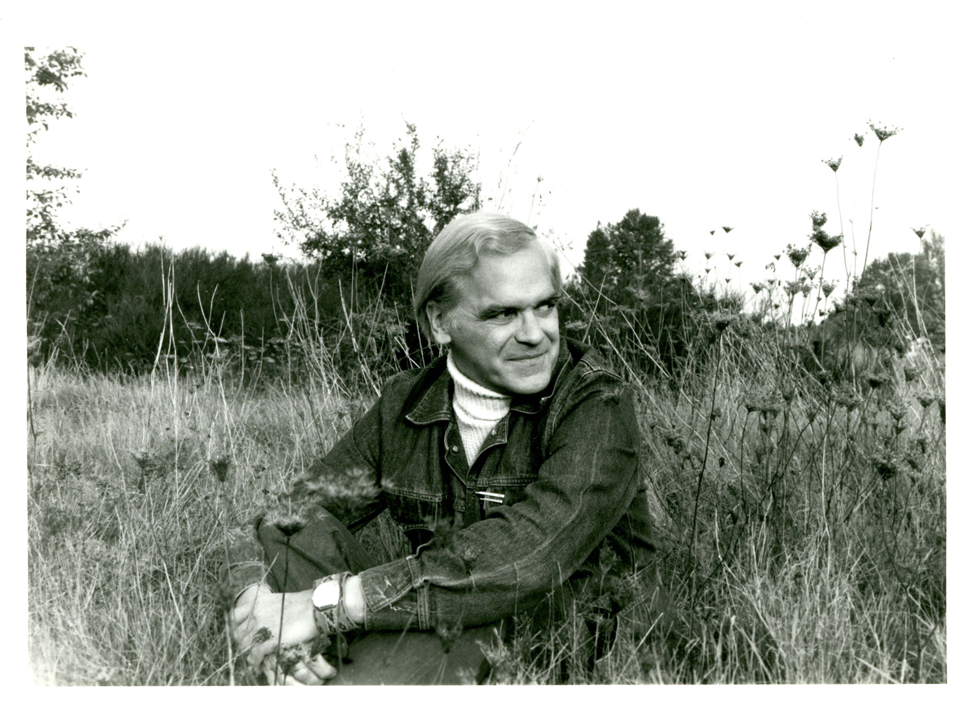 David Wagoner sitting in a field