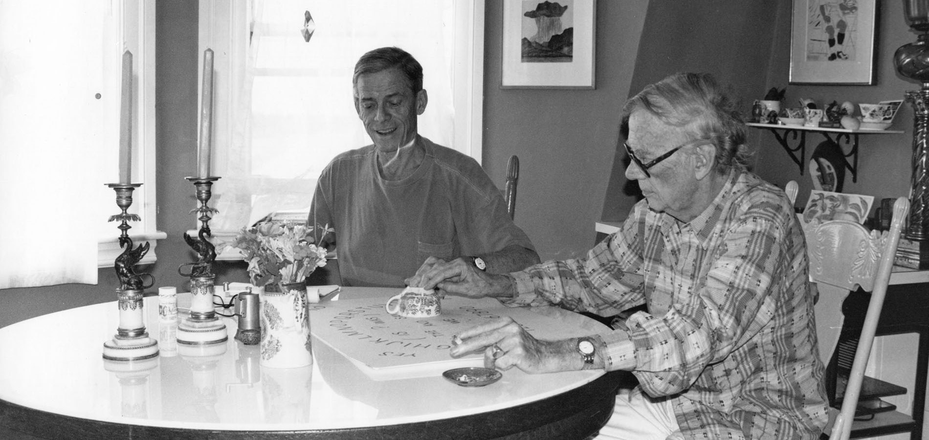 James Merrill and David Jackson seated at a Ouija board.