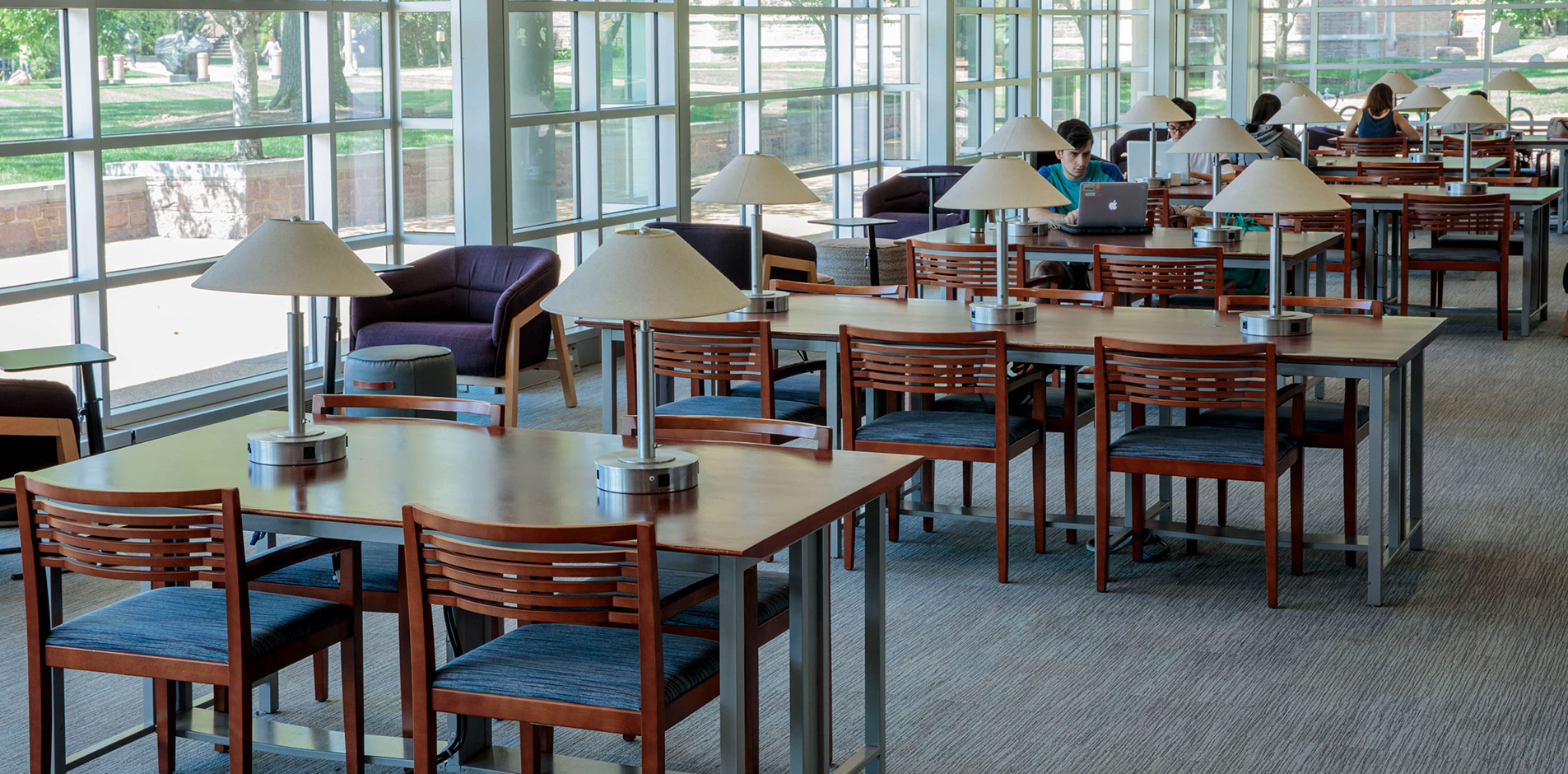 Study tables and chairs along the windows of Olin Library.