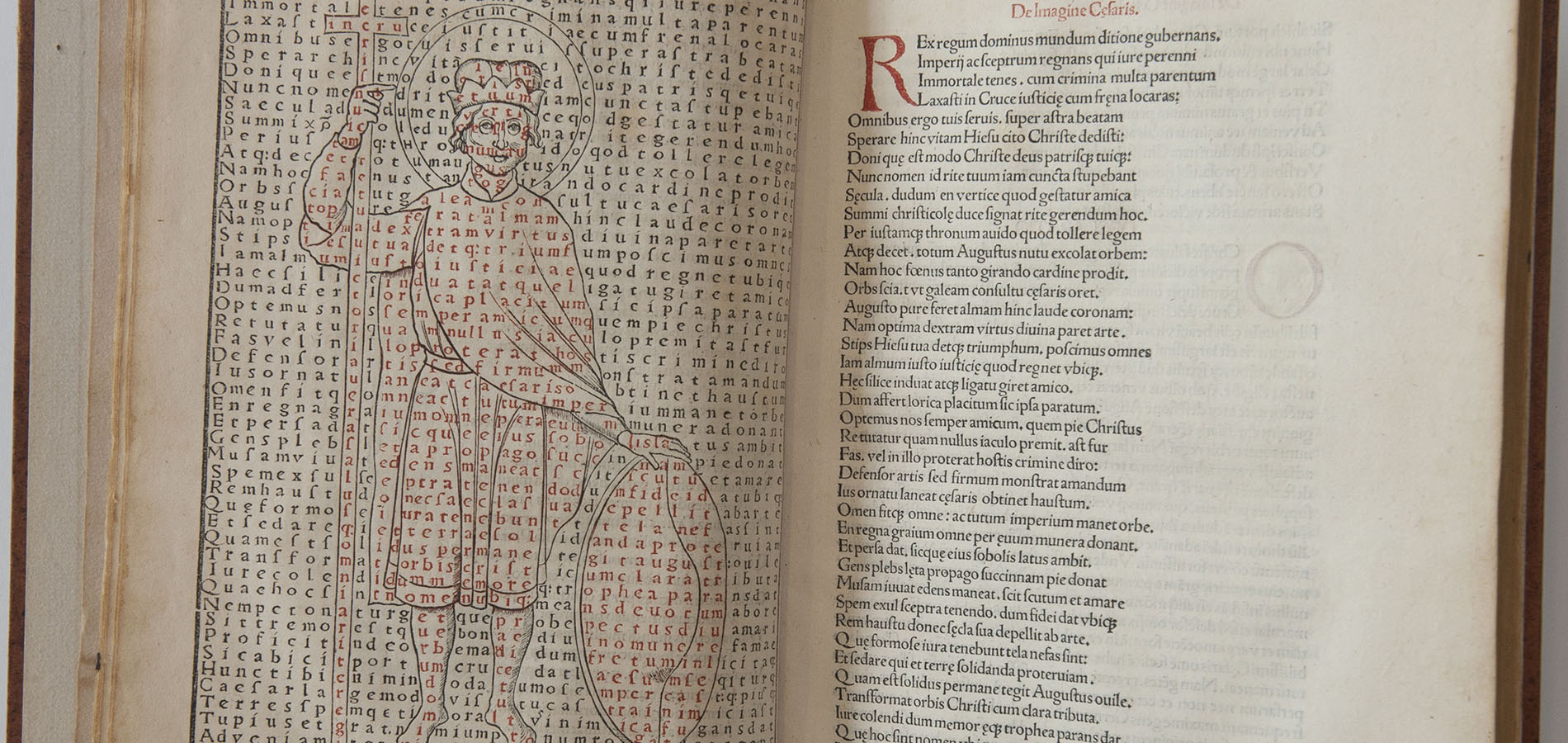 A text with a Hrabanus Shield Man drawn in the middle; text within the lines of the shield man is a different color (red) from the rest of the text on the page (black).