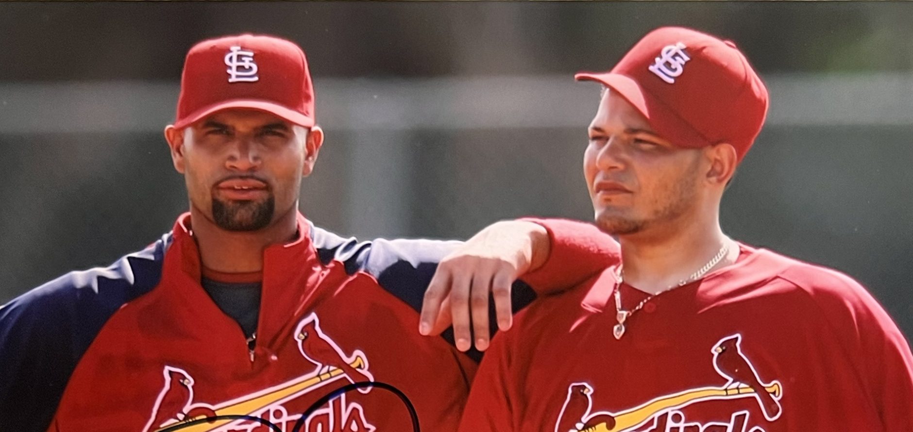 Yadier Molina and Albert Pujols standing on the field near home plate for a promotional photo.