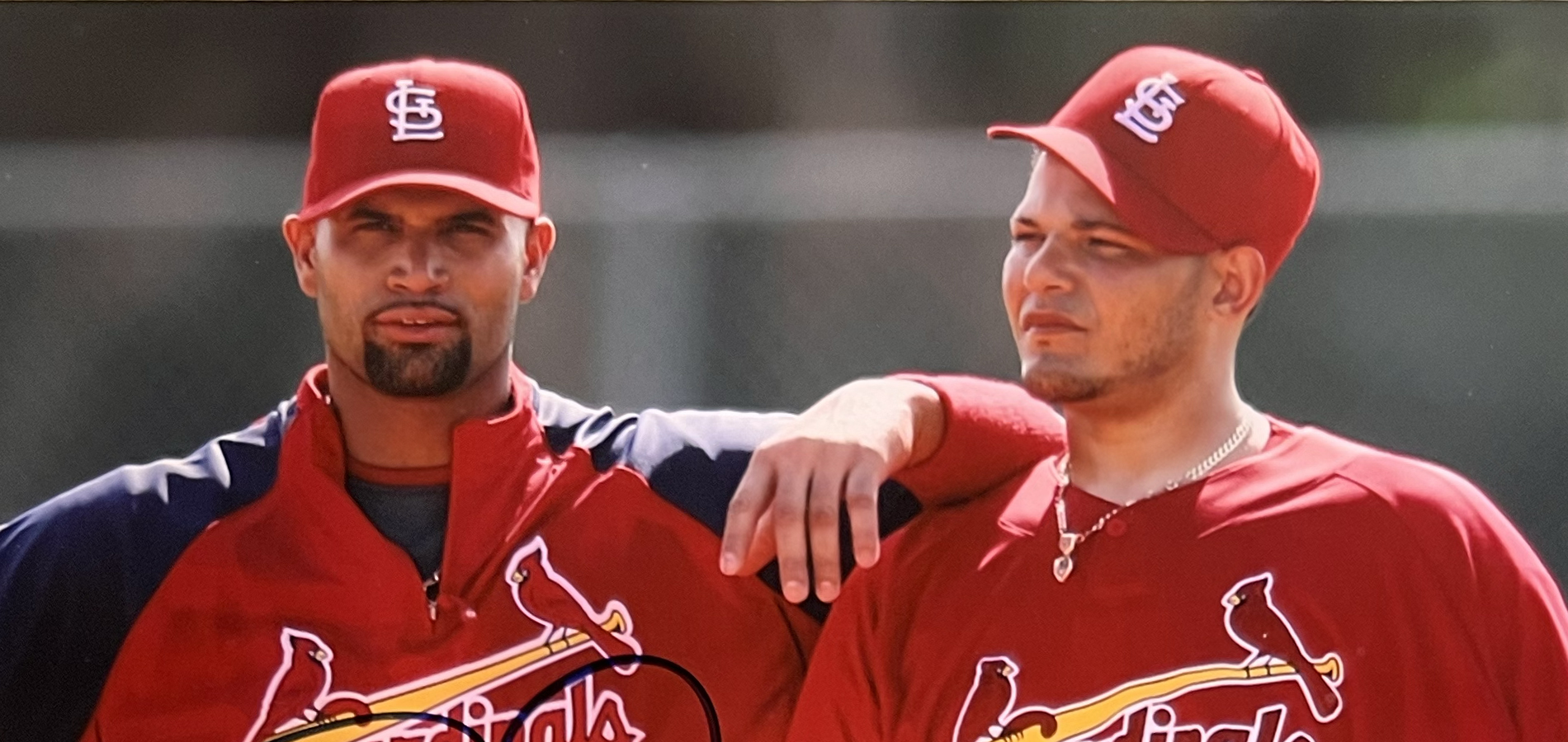 Yadier Molina and Albert Pujols standing on the field near home plate for a promotional photo.