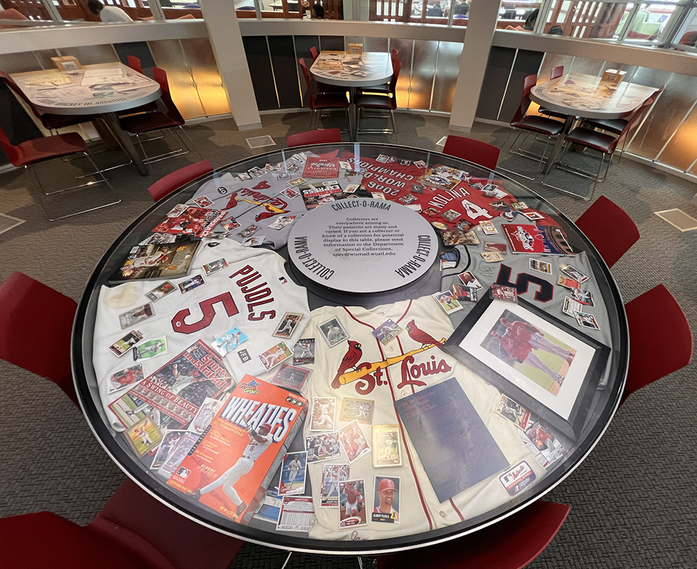 Cardinals memorabilia featuring Yadier Molina and Albert Pujols on display in the Collect-o-Rama case in Olin Library.