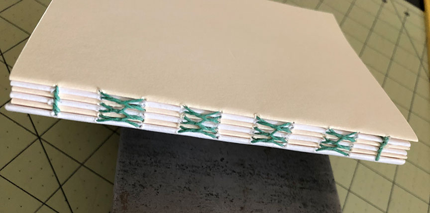The bare stitching on a book spine.