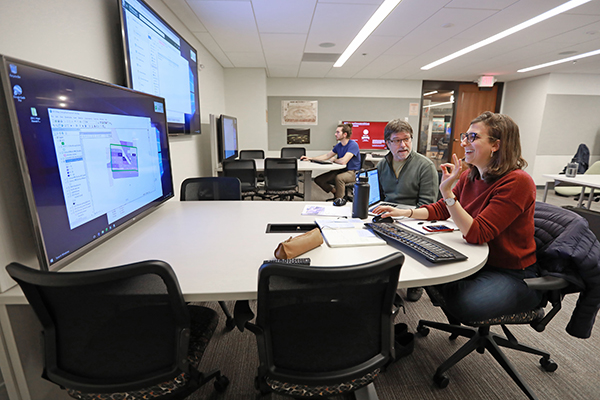 Library Staff assist a student using Research Studio tools on Level A of Olin Library.