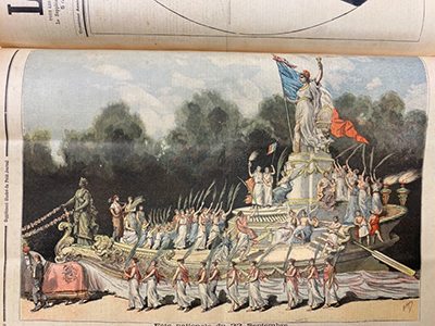 A statue of a woman holding a torch above her head and a national flag in the other is being paraded on a ship drawn on land by a horse with men and women celebrating around both the ship and the statue.