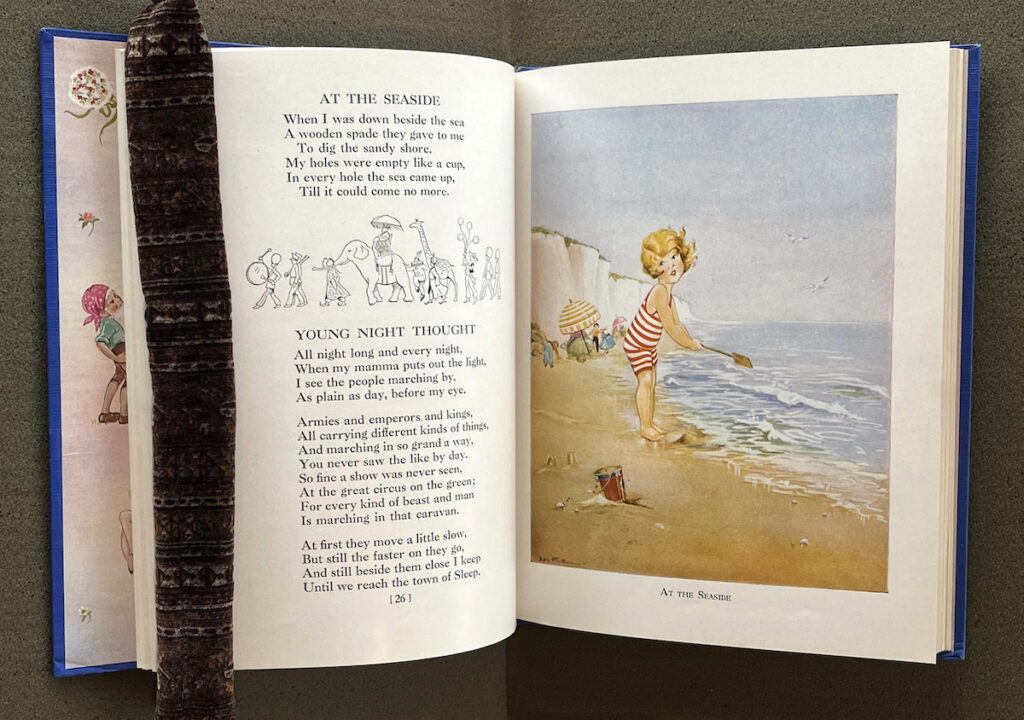 A page of poems and a facing page with the drawing of a child playing on the seaside.