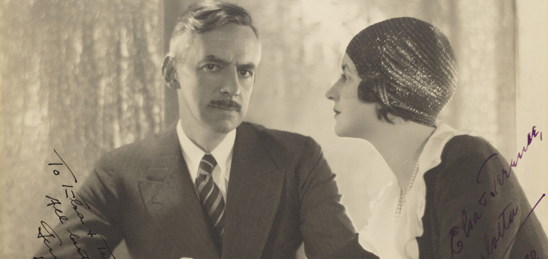 Carlotta and Eugene O'Neill dressed in a dress with pearls and suit, respectively, at a party in Le Plessis, France.