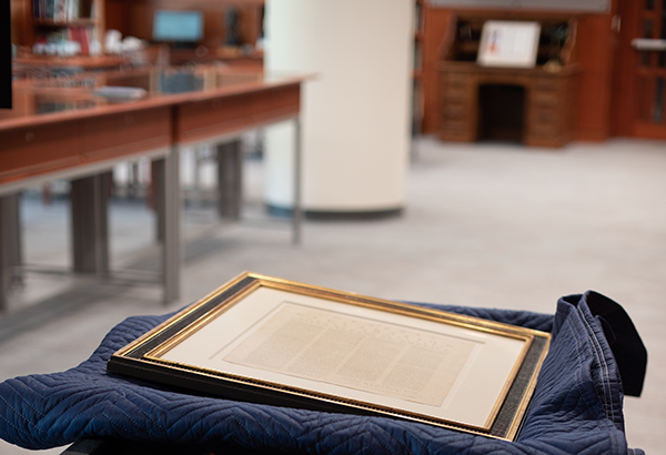 The framed Rogers Broadside traveling through Special Collections to be on display within the Declaration of Independence Case in Olin Library.