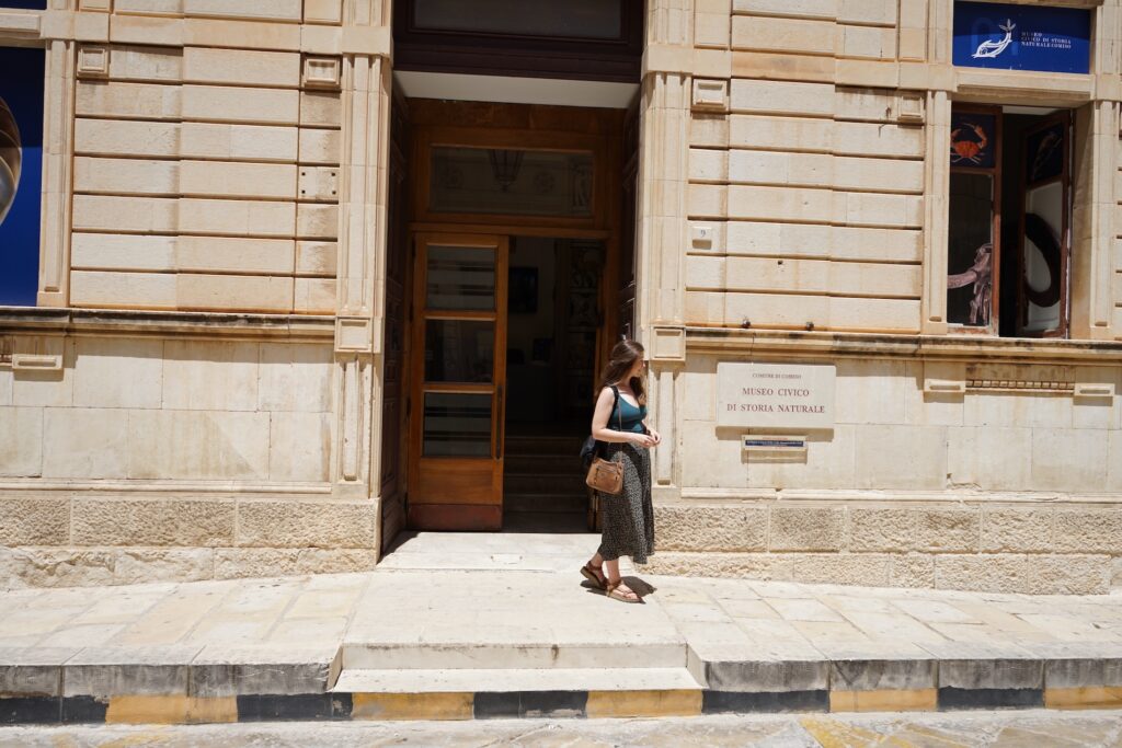 A woman outside a large building