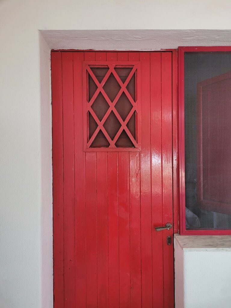 A long red door with a rectangular lattice