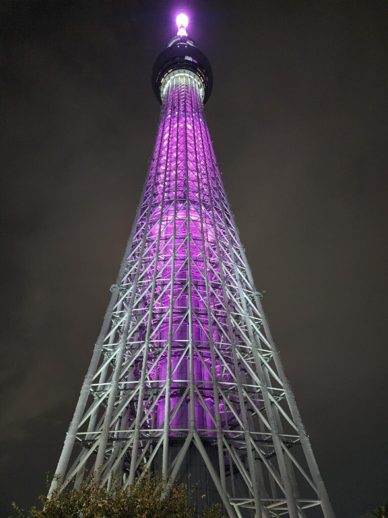 Tall tower lit up with a purple glow