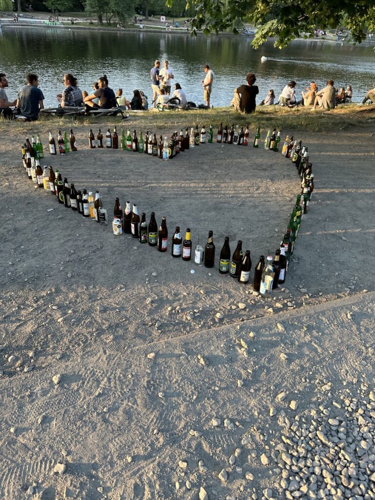 bottles in a heart shape on a river bank