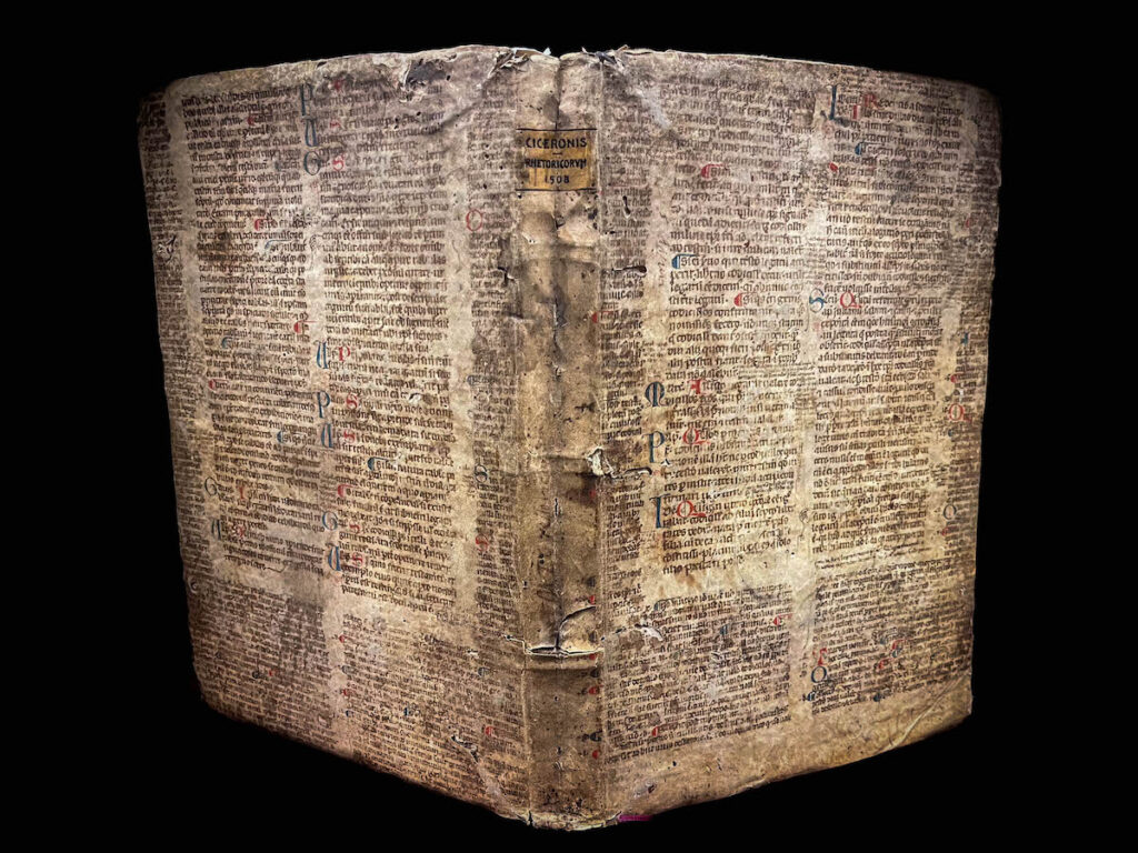 Upright book with wrapper covered in a medieval script