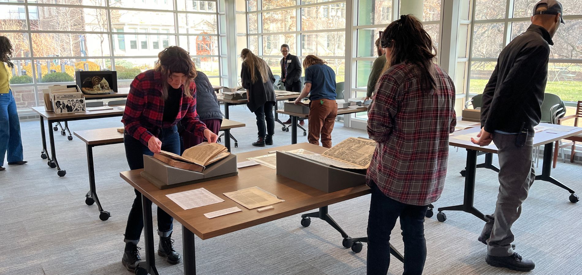 People looking at materials in the special collections reading room.