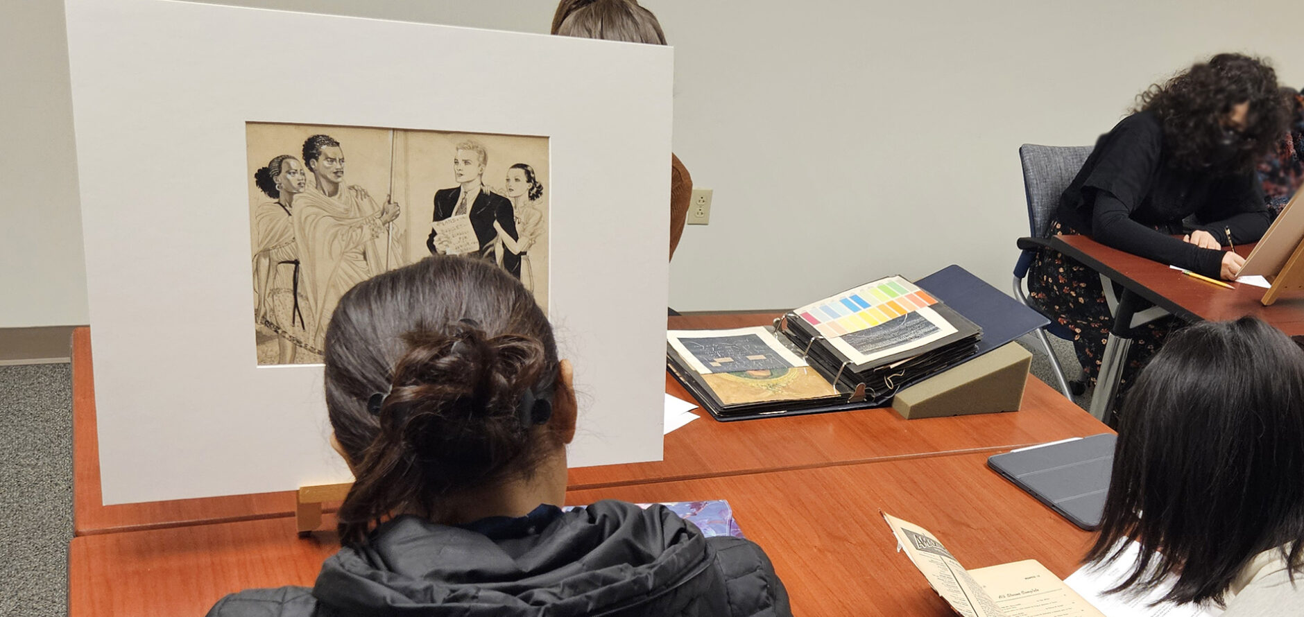 Master of Fine Arts in Illustration and Visual Culture (MFA-IVC) students investigating materials from the Dowd Illustration Research Archive (DIRA) as a part of their Exhibition & Engagement course.