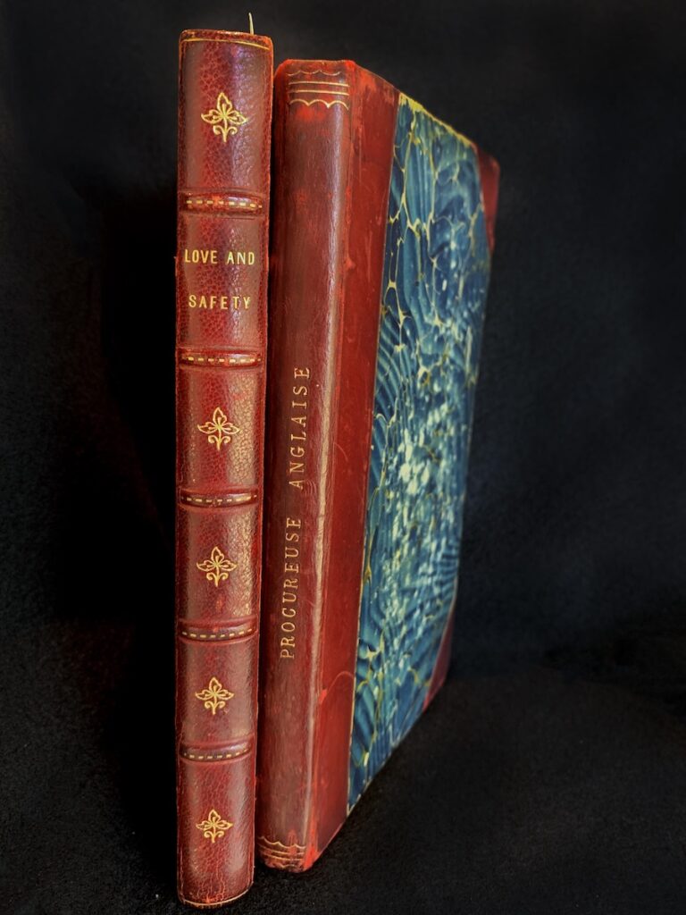 Two books with red binding on the spine