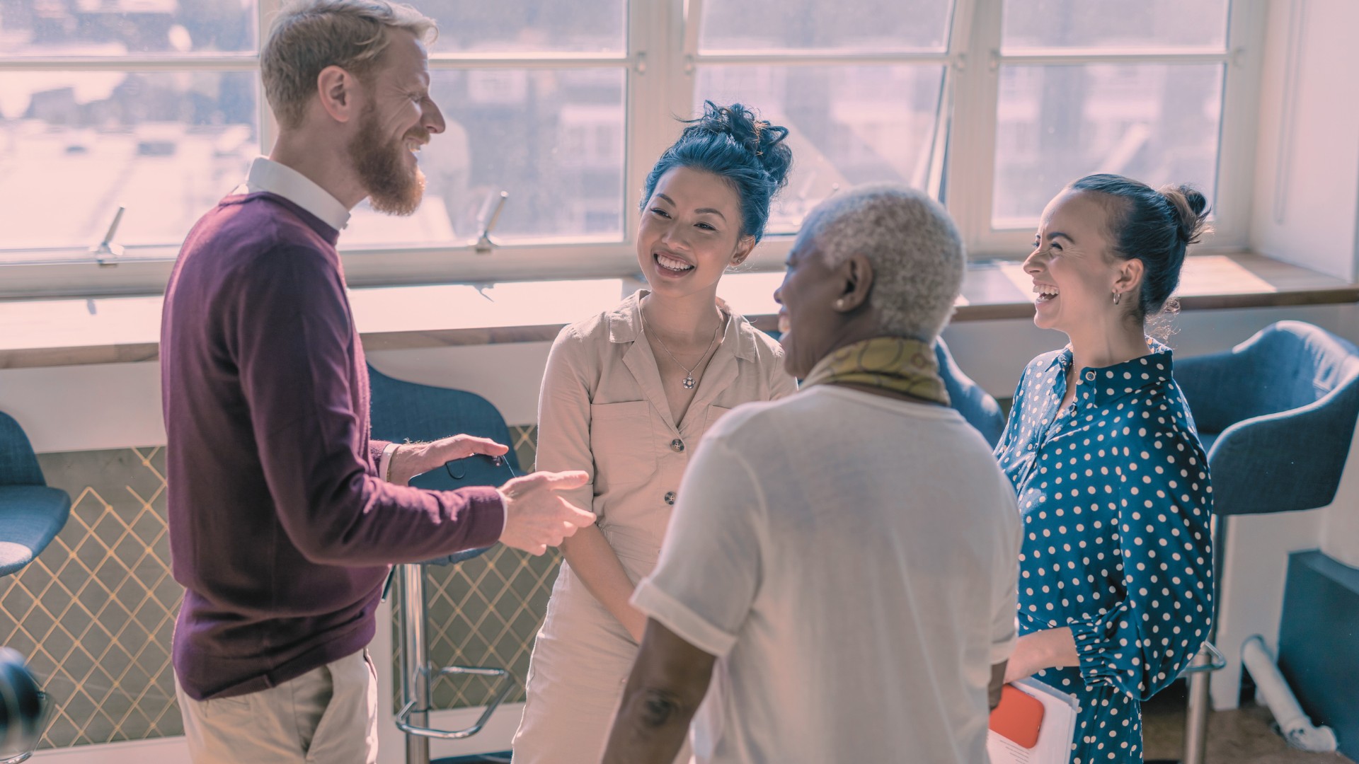 Stock photo of four adults engaged in a conversation