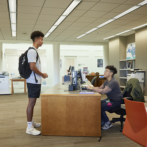 Student at the Help Desk in the Business Library.