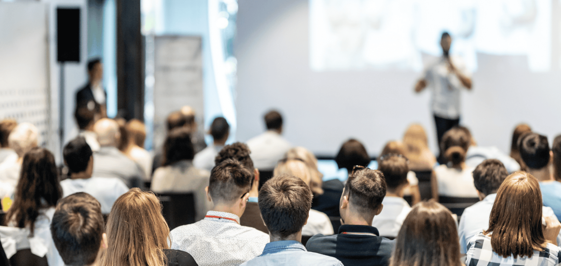 Stock photo of people attending a business presentation